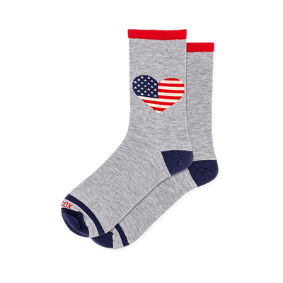 Grey crew socks featuring a heart shaped American flag pattern with stars and stripes, red cuffs, and solid navy toes.