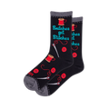 Pair of black crew socks featuring 'Snitches get Stitches' text, red thread spools, buttons, and white sewing needles.
