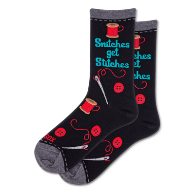Pair of black crew socks featuring 'Snitches get Stitches' text, red thread spools, buttons, and white sewing needles.