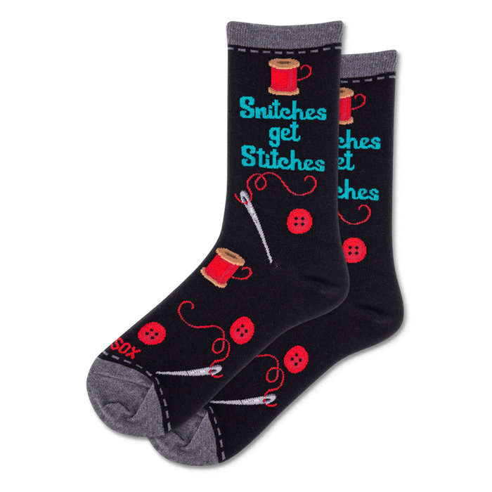 Pair of black crew socks featuring 'Snitches get Stitches' text, red thread spools, buttons, and white sewing needles. }}