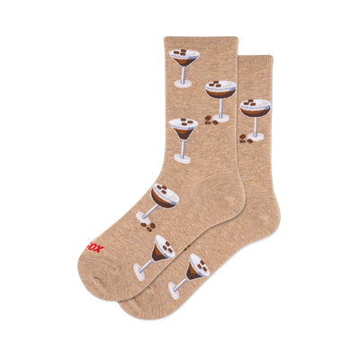 Pair of crew socks in a light brown/tan color with a repeating pattern of espresso martini cocktails topped with coffee beans.