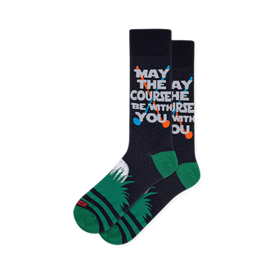 Navy socks showing May the Course Be With You text, crossed clubs, a green heel, and a white golf ball in the grass.