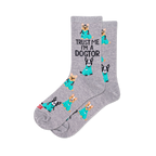 Pair of grey crew socks with a repeating pattern of cartoon dogs in teal medical scrubs, some with stethoscopes. Text reads "TRUST ME I'M A DOGTOR".