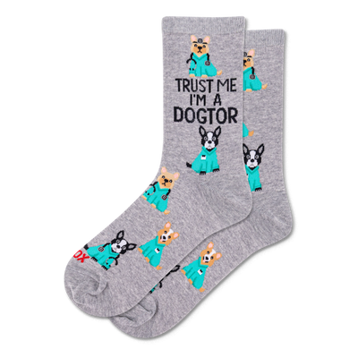 Pair of grey crew socks with a repeating pattern of cartoon dogs in teal medical scrubs, some with stethoscopes. Text reads "TRUST ME I'M A DOGTOR".