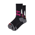 Black crew socks featuring bright pink Yes Chef text next to a silver chef knife graphic, complete with grey heels and toes.