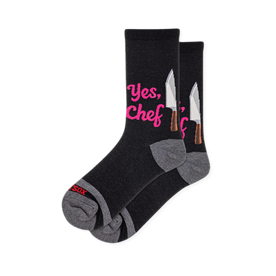 Black crew socks featuring bright pink Yes Chef text next to a silver chef knife graphic, complete with grey heels and toes.