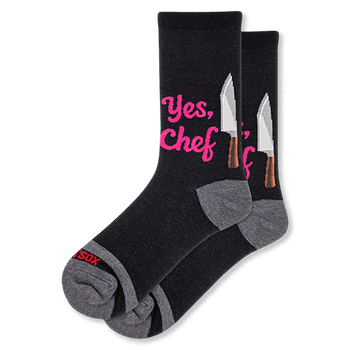 Black crew socks featuring bright pink Yes Chef text next to a silver chef knife graphic, complete with grey heels and toes.