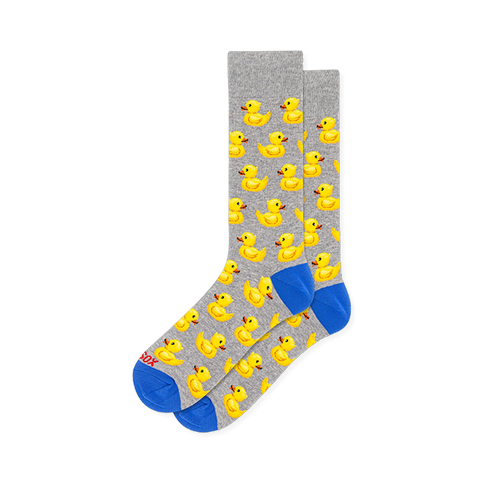 Light grey crew socks showing a repeating yellow rubber duck pattern with bright blue accents on the toes and heels. }}