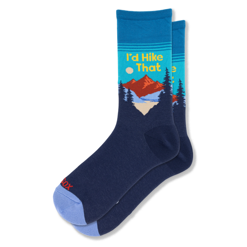 Navy and teal crew socks with a red mountain, dark pine trees, and yellow text reading I'd Hike That. Features a blue toe.