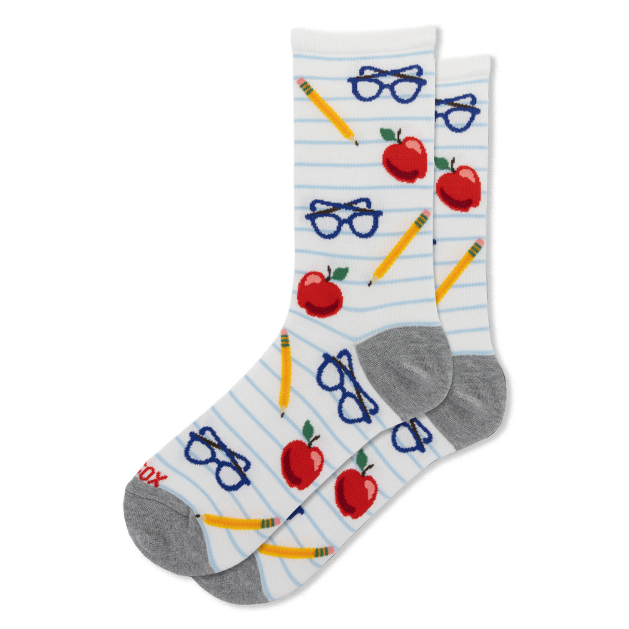 White socks with blue lined paper pattern showing red apples, yellow pencils, and blue eyeglasses. Gray heels and toes.