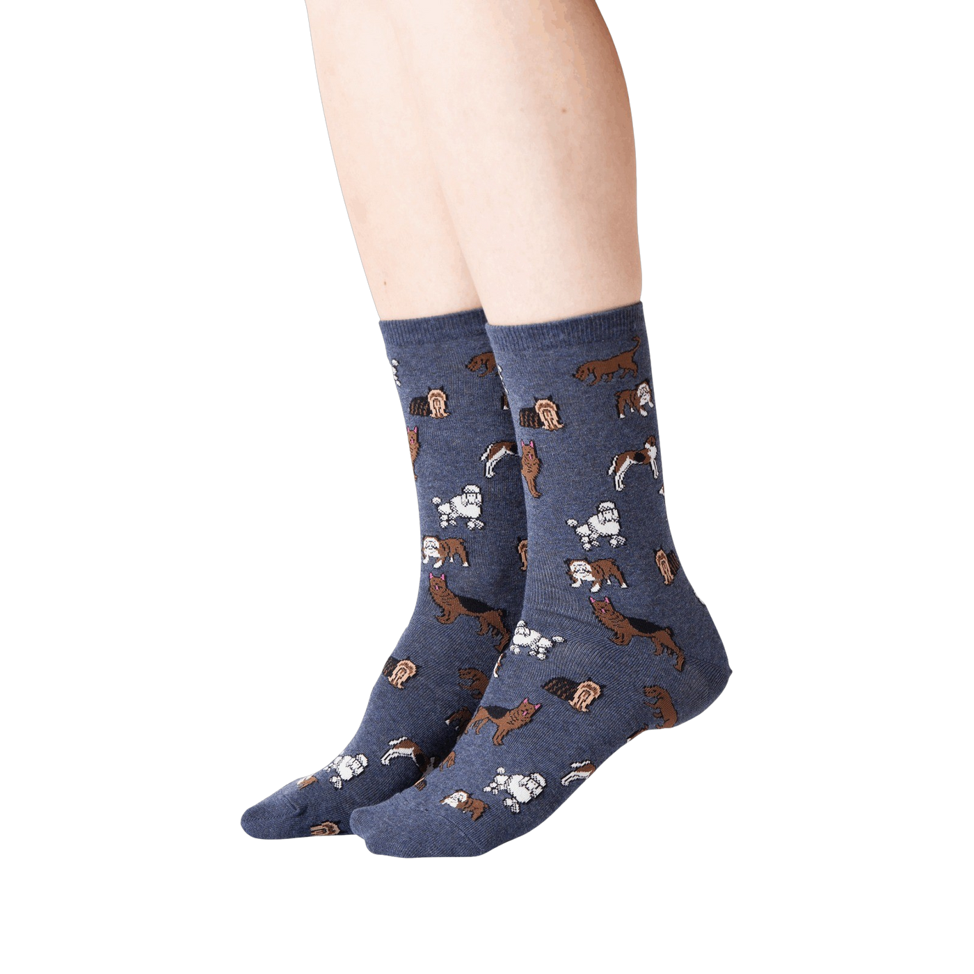 Lifestyle shot of woman's legs wearing navy blue crew socks with dogs on them.