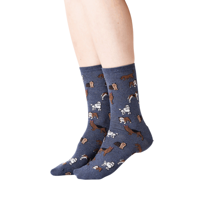 A pair of blue socks with a pattern of various dog breeds in brown.
