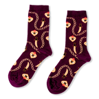 Burgundy crew socks showing a pattern of golden chains, curved daggers, and flaming hearts with an eye in the center.