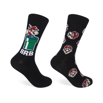 Two black crew socks. One features Mario in a green pipe, the other has repeating Mario head designs. Both socks have red and white accents.