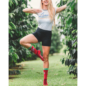 Lifestyle photo: Woman balancing on one leg, showcasing the socks in a natural setting.