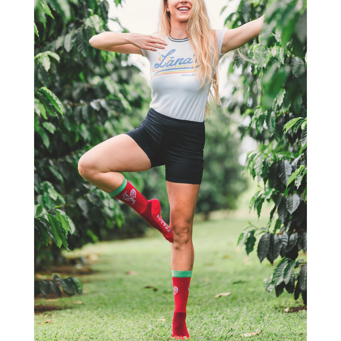 Lifestyle photo: Woman balancing on one leg, showcasing the socks in a natural setting.