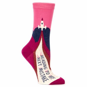 Crew socks in pink, burgundy, and navy blue.  Features a rocket launching design and the text 'Heading To My Next Mistake'.
