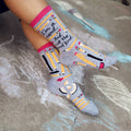 Lifestyle shot of a person wearing the 'I'm a Nerd' socks, showcasing how they look when worn. The socks are visible from the ankles down. [lf]