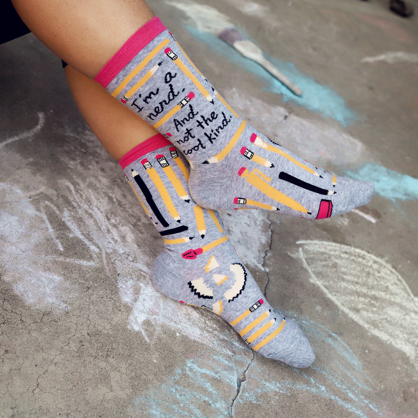 Lifestyle shot of a person wearing the 'I'm a Nerd' socks, showcasing how they look when worn. The socks are visible from the ankles down. [lf]