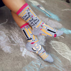 Lifestyle shot of a person wearing the 'I'm a Nerd' socks, showcasing how they look when worn. The socks are visible from the ankles down. [lf]