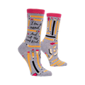 A pair of gray crew socks with a pink band at the top.  The socks are adorned with yellow pencils and the text, 'I'm a nerd. And not the cool kind.'