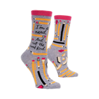 A pair of gray crew socks with a pink band at the top.  The socks are adorned with yellow pencils and the text, 'I'm a nerd. And not the cool kind.'