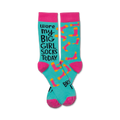Pair of teal crew socks with hot pink cuffs.  Features a playful saying and orange/pink sock-shaped designs.