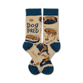 Cream crew socks with teal cuffs, featuring brown dogs sleeping and playing, and the phrase 'Dog Tired'.