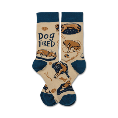 beige crew socks with sleepy cartoon dog pattern, "dog tired" stitched in cursive, navy cuffs and toes.   