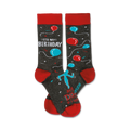 A pair of crew socks in grey with red cuffs. The socks feature teal and red balloons, a dancing figure, and the text 'It's My Birthday'.