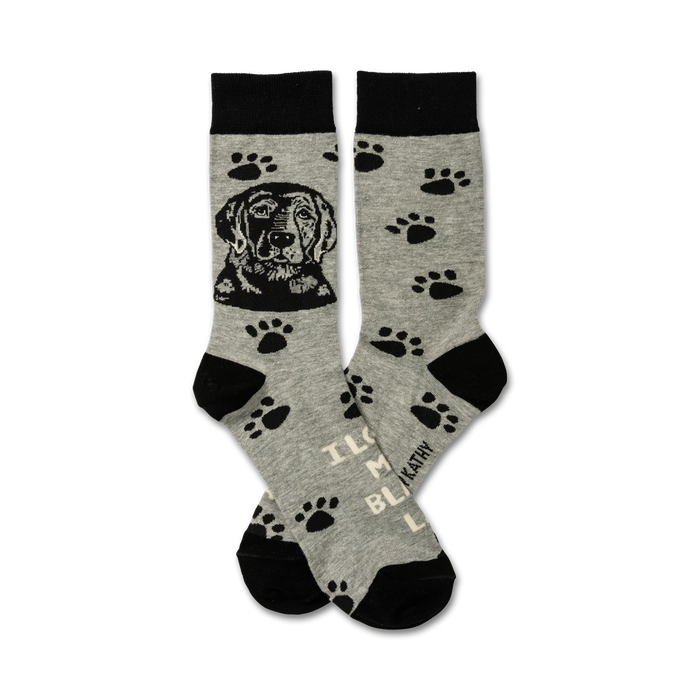 dog-themed socks in gray with black tops, toes, and paw prints. black dog heads on the front; 