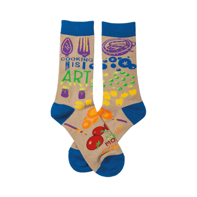 Crew socks in beige with royal blue cuffs.  The design includes colorful illustrations of cooking utensils and food, along with the text 'Cooking Is Art'.