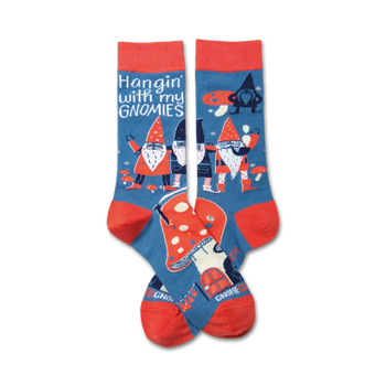 A pair of crew socks in blue and red. The socks feature a whimsical design of gnomes, mushrooms, and the phrase 'Hangin' with my gnomies'.