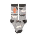 Gray crew socks with a repeating pattern of black and white dogs, an orange arrow, and the text 'Awesome Dog Mom'.