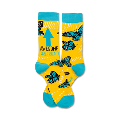 crew length yellow socks with blue toe, heel, and cuff feature "awesome girlfriend" text and a blue arrow pointing up along with scattered butterflies and polka dots.  