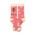 Pair of pink crew socks with a cream cuff.  Features a brown arrow pointing up and the words 'Awesome Wife' and a scattered daisy pattern.