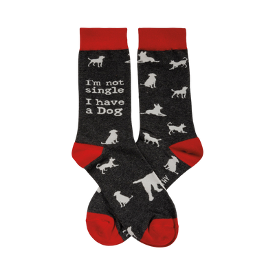 Crew socks in dark gray with red cuffs.  White dog silhouettes and the text 'I'm not single I have a Dog' are printed on the socks.