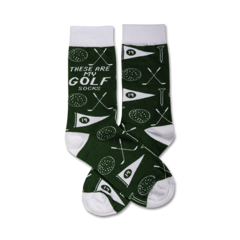 dark green golf socks with white toe, heel, and top. features pattern of golf balls, golf clubs, and the words 'these are my golf socks.' men's crew length in cotton blend. machine washable.   