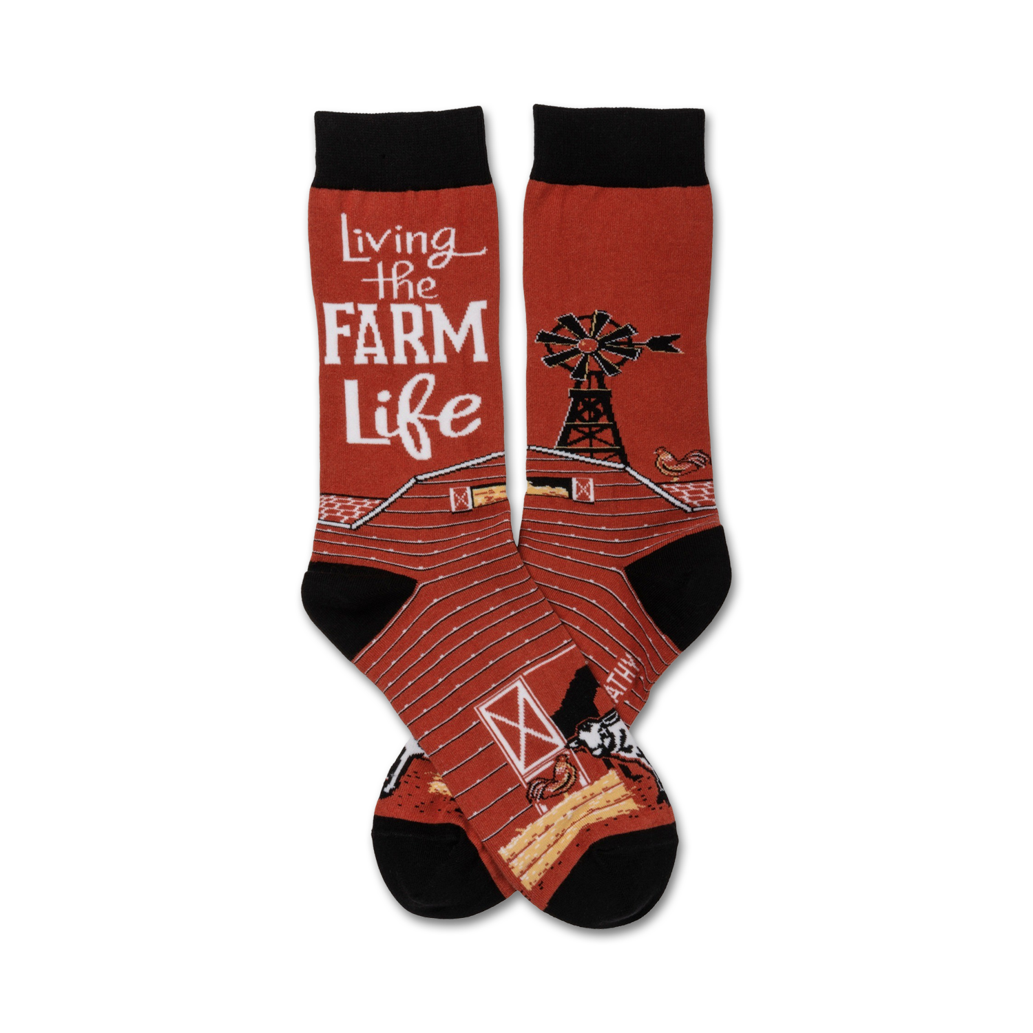 A pair of crew socks in red and black features a barn, windmill, chicken, and cow. The text 'Living the Farm Life' is prominently displayed.
