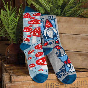 A pair of gray socks with a pattern of red and blue gnomes with white beards.
