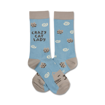 Pair of crew socks in light blue with grey cats and swirls. Text reads "Crazy Cat Lady".