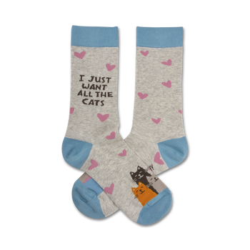 Pair of crew socks in grey with light blue cuffs.  Pink hearts and a drawing of two cats are featured on the socks. The text 'I Just Want All The Cats' is also displayed.