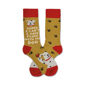  mustard yellow crew socks with red toes, heels, and cuffs feature brown paw prints and a cartoon dog with a wine glass saying, "sorry, i can't, i have plans with my dog."   