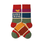 Pair of crew socks in rainbow stripes; red, purple, blue, green, yellow, orange, and cream.  Features 'LOVE WINS' text and a yellow heart.