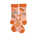 Pair of pink crew socks with an orange tomato pattern and the text 'Tomato Whisperer'.