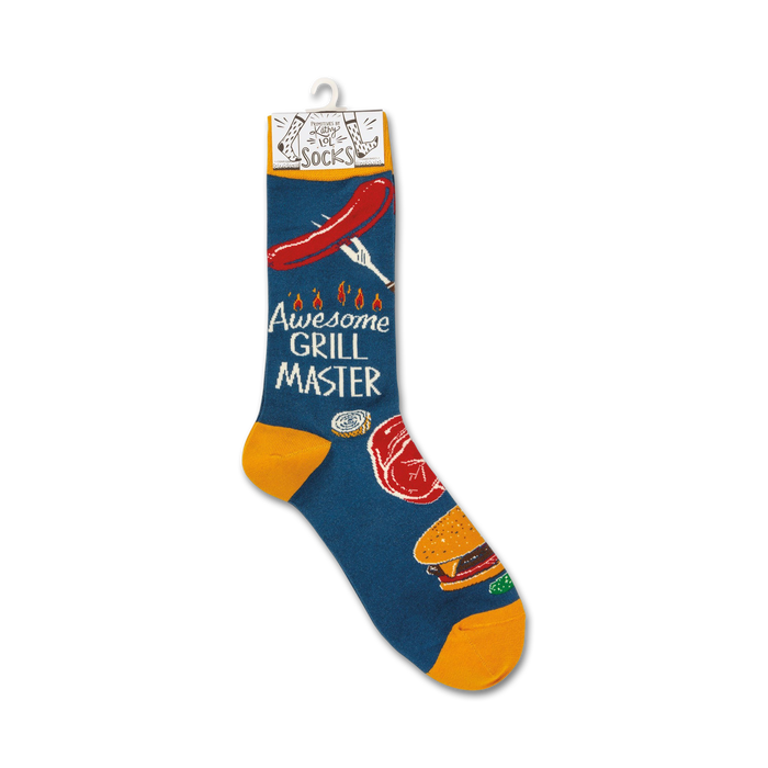 A pair of blue socks with a pattern of grilling items, including a hot dog, a steak, a hamburger, and a grill fork. The socks are labeled 