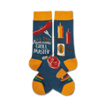 Pair of blue crew socks with yellow cuffs.  Features a fun BBQ design with hot dogs, burgers, and grilling tools.
