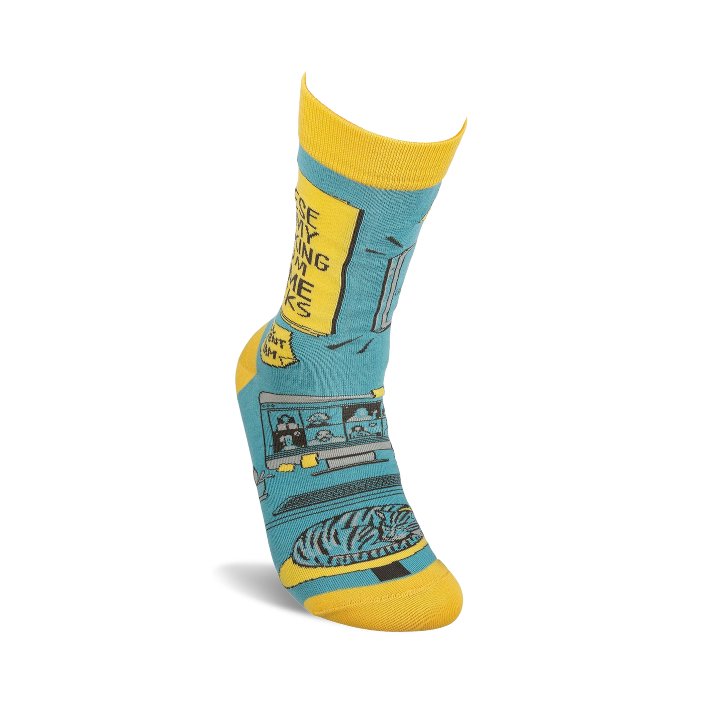 Lifestyle shot of a person's foot wearing one of the teal and yellow 'Working From Home' socks.