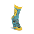 Lifestyle shot of a person's foot wearing one of the teal and yellow 'Working From Home' socks.