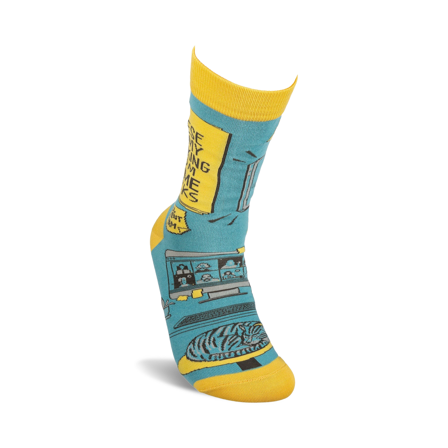 Lifestyle shot of a person's foot wearing one of the teal and yellow 'Working From Home' socks.